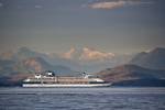 Backdropped by the scenic waterways off Northern Vancouver Island and the Coast Mountains of BC, a cruise liner navigates the waters of the Inside Passage on a journey of adventure.