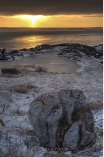 The frozen landscape along the Hudson Bay in Churchill, Manitoba glistens in the sunset lighting during the winter.