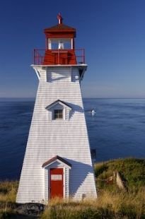 Atop the cliffs of Long Island near Tiverton, Nova Scotia, the Boar's Head Lighthouse aids mariners through the Bay of Fundy.