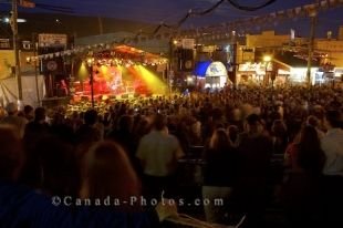 Crowds of people swarm to the nightly outdoor concerts held during the George Street Festival in St. John's in Newfoundland, Canada.
