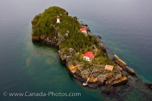 An aerial view shows Lake Superior surrounding the rocky Trowbridge Island and the lighthouse that was built in 1910.
