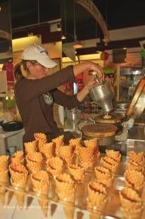 Photo of woman making waffle cones at a store (Cow's) in the town of Niagara-on-the-Lake, Ontario, Canada.